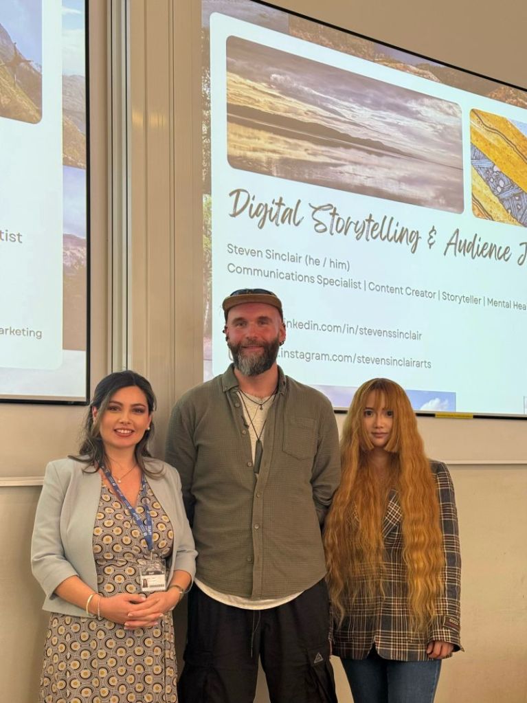 Steven Sinclair with Dr Ying Wu and a colleague in front of his Digital Storytelling and Audience Engagement slide