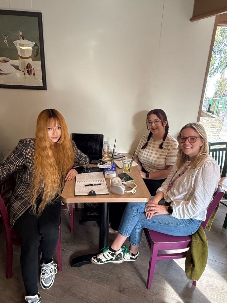 Dr Ying Wu and two colleagues at a café table during a planning meeting